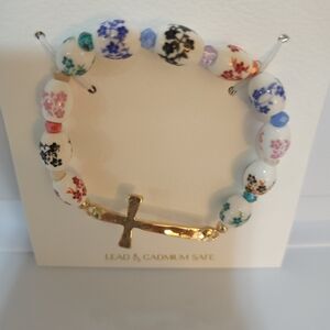 Gold Cross Bracelet w/ Ceramic Beads Floral Decoration 2-1/2" diam stretch cord